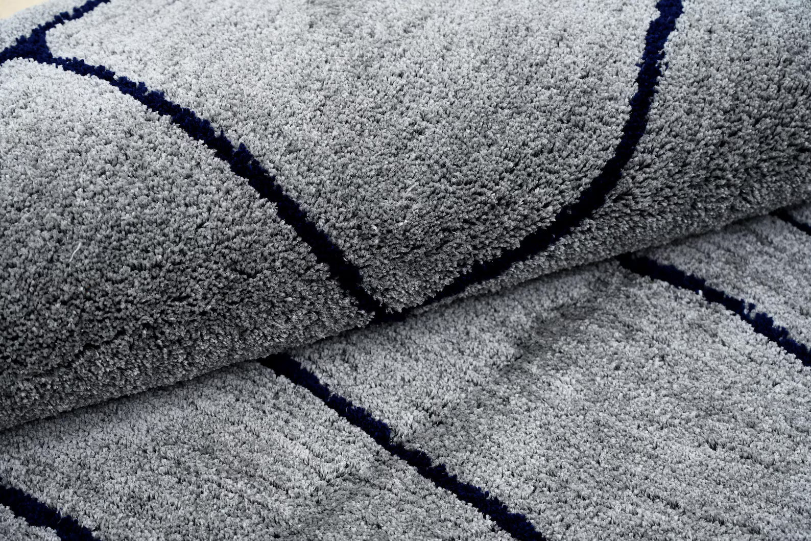 Close up view of abstract grey rug